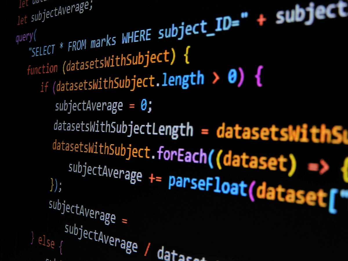 Developer writing JavaScript code — custom development vs no-code tools